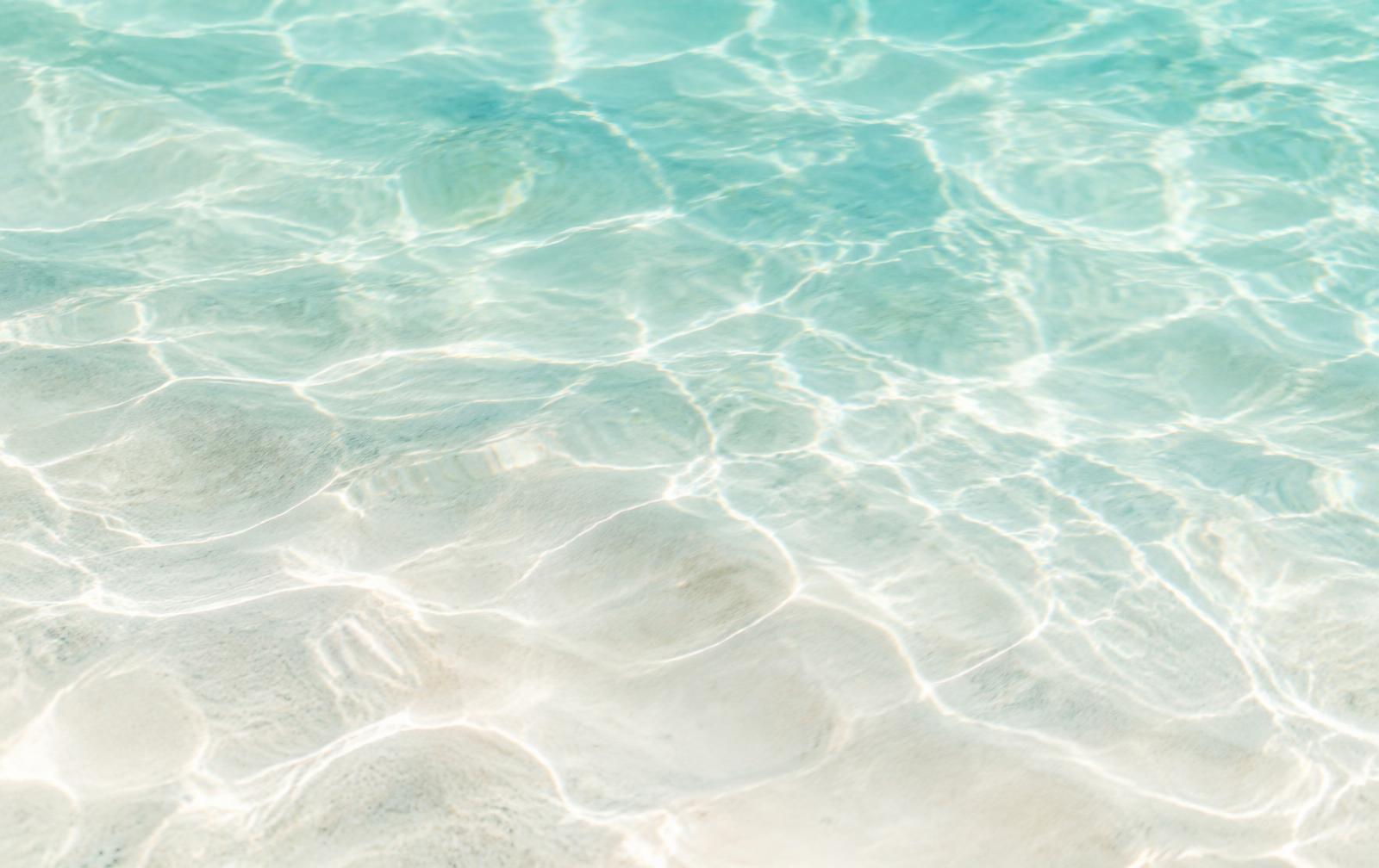 Light rippling through clear shallow water